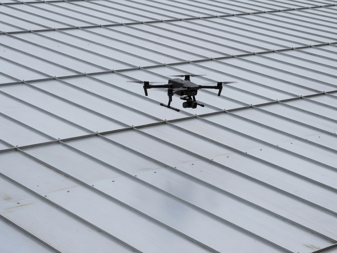 Unmanned aerial vehicle conducting an automated photogrammetric flight path over a standing seam metal roof